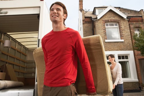 Professional movers handling office furniture in South London