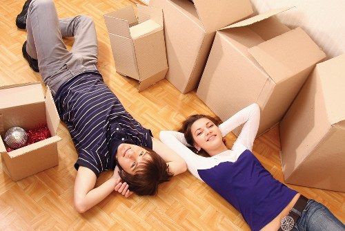 Team member wearing PPE while carrying furniture safely